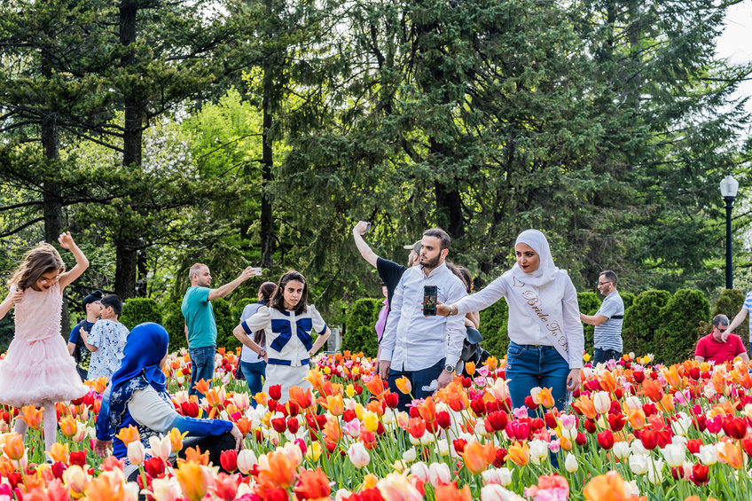 MONTREAL, QUEBEC, CANADA - MAY 21, 2018: People at park. Locals and tourists in Montreal flower park garden zone.